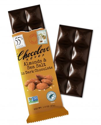 A Chocolove Almonds & Sea Salt in Dark Chocolate bar is partially unwrapped, revealing deep, dark chocolate squares with embossed heart designs. The wrapper is a warm brown color with an elegant, vintage-inspired design. It features an image of whole almonds sprinkled with sea salt, emphasizing the rich, crunchy texture. A 55% cocoa label is displayed in the top left corner, with a stamp-style illustration of almonds and a red Belgian Chocolate seal near the top. The chocolate bar’s glossy surface highlights the premium Belgian dark chocolate quality.