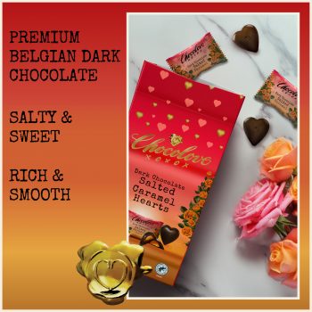 Chocolove Dark Chocolate Salted Caramel Hearts packaging displayed with individually wrapped chocolate hearts and roses on a marble background. Text reads 'Premium Belgian Dark Chocolate,' 'Salty & Sweet,' and 'Rich & Smooth.' The box features red and gold heart designs with floral accents.