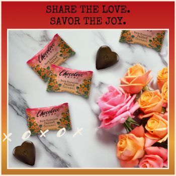 Chocolove Dark Chocolate Salted Caramel Hearts displayed with vibrant pink and orange roses. Individually wrapped chocolates with floral packaging and heart-shaped chocolates scattered on a marble surface. Text overlay reads 'Share the Love. Savor the Joy.' with playful 'xoxo' accents