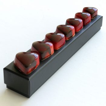 Heart Shaped Cherry Cordials on top of an elegant black gift box - Chocolove Cherry Cordials Valentine's Day Gift Box